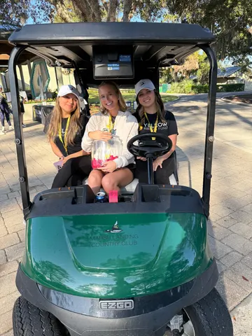 Tournament volunteer with a golf cart